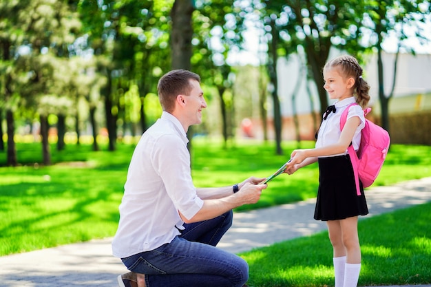 父は1年生の娘を学校に導きます