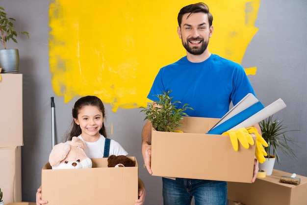 Father and little daughter are planning to make house repair