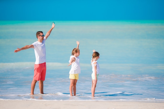 Father and little kids enjoying beach summer tropical vacation. Family playing on the beach