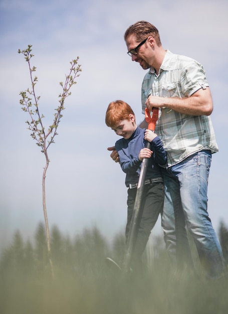 Father and little son planted a seedling work together