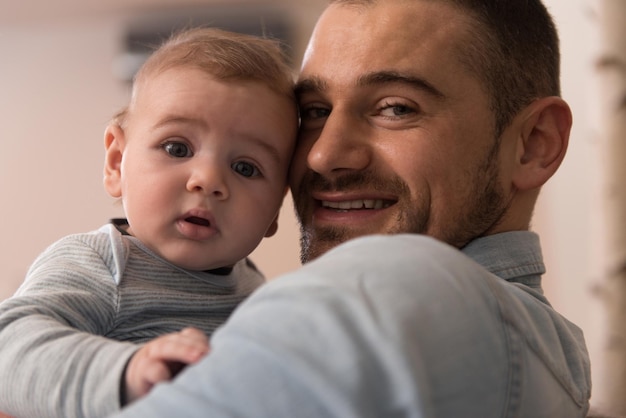 Father in Living Room With Baby Smiling