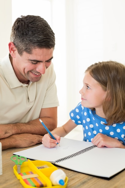 Father looking at daughter drawing