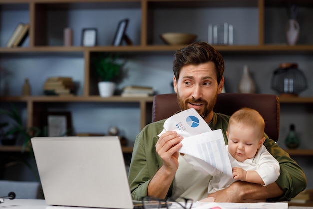Father on maternity leave holding an online conference a meeting in the home office with a small child in his arms Dad with a child Freelancer combines child care and work Paternity leave
