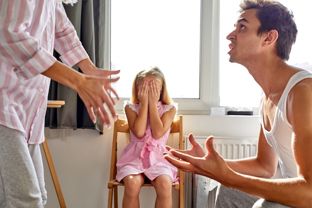 Father and mather is fighting quarrelling but daughter very sad, they argue, girl is suffering from unhappy childhood