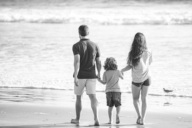 Father mother and child on the summer beach at the sunset time on maui concept of friendly family