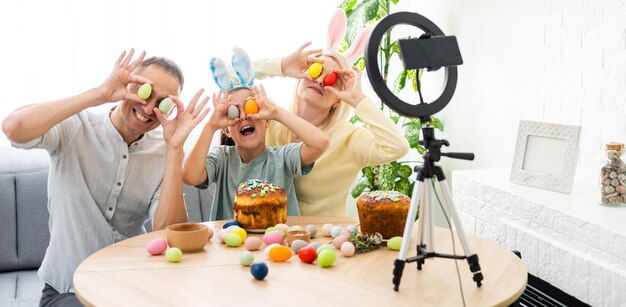 Father, mother and her child enjoy painting Easter eggs. Shop Online for happy easter decoration. Easter eggs - color egg assortment.