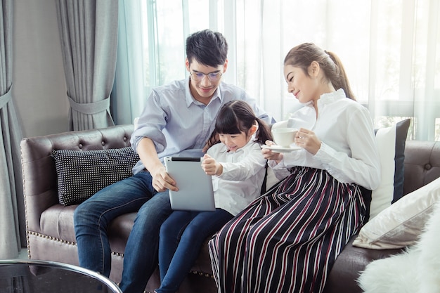 Father and mother Teaching children to do their homework at home, Asian family is happy.