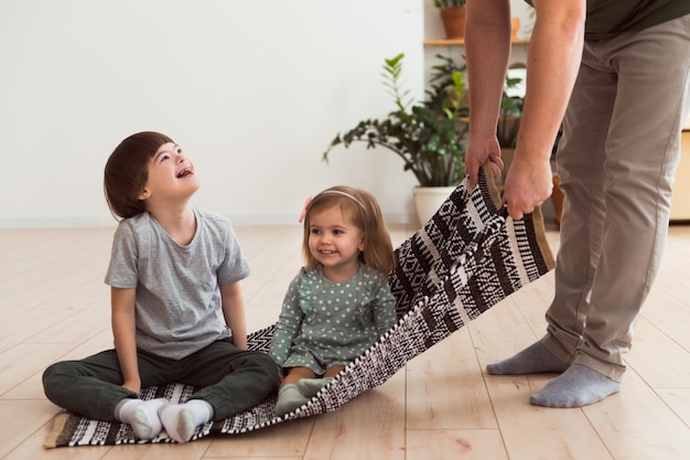 Father playing with children son with down syndrome and daughter