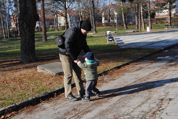 Photo father playing with son on road