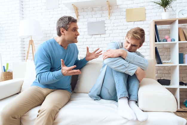 Father reaches out with his hand unhappy son