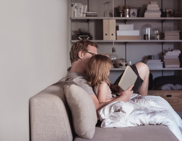 father reading story to daughter