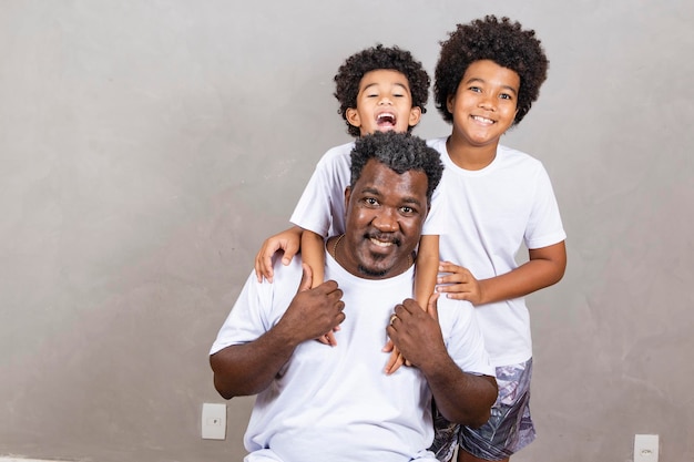 Father's Day Black father with his two afro kids on white background