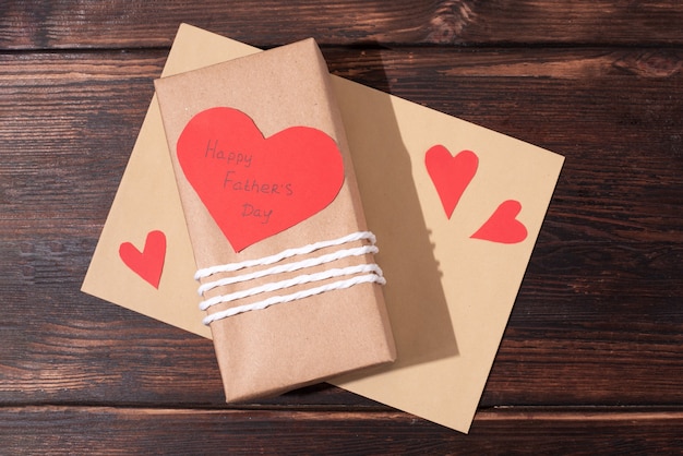 Father's day gift wrapped in craft paper and heart shaped card, envelope .