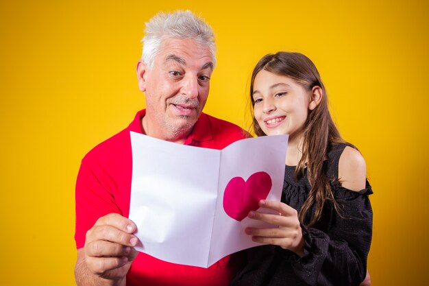 Father's day. happy daughter with greeting card on holiday