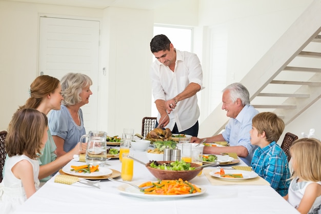 Father serving meal to family