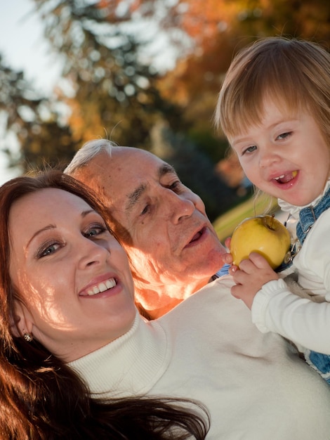 Photo father sharing a moment of happiness with his daughter and grandaughter.