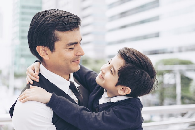 Father single dad and son Hugging son on business district urban