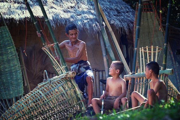 Father and son are working hand made basket bamboo