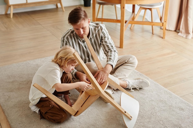 Father and Son Assembling Chairs