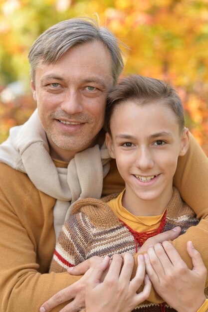 Father and son in autumn park