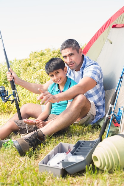 Father and son beside tent