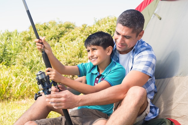 Father and son beside tent