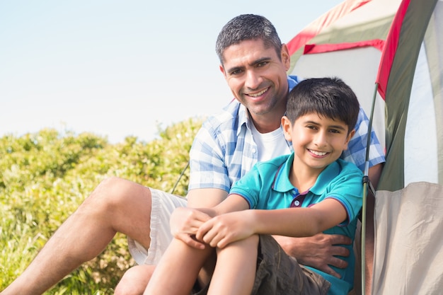 Father and son beside their tent