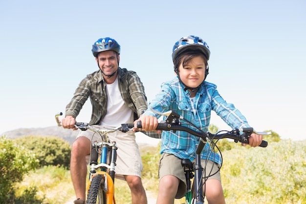 Father and son biking through mountains