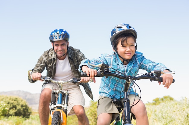 Father and son biking through mountains