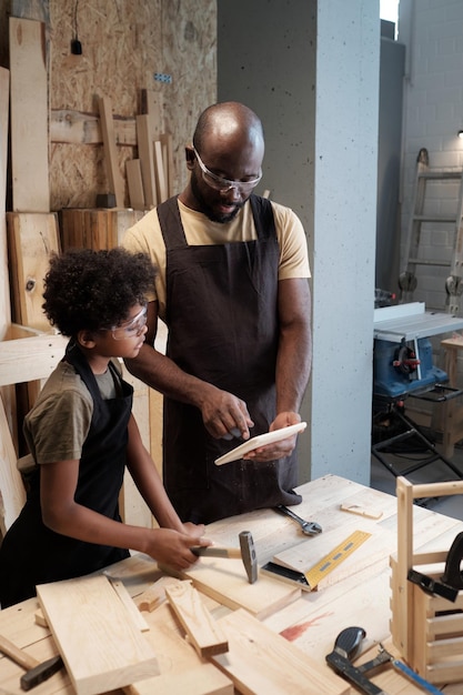 Father and son bonding in workshop