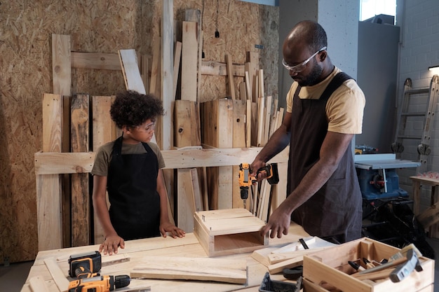 Father and son building birdhouse