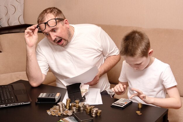 A father and son calculate the family budget during a crisis.