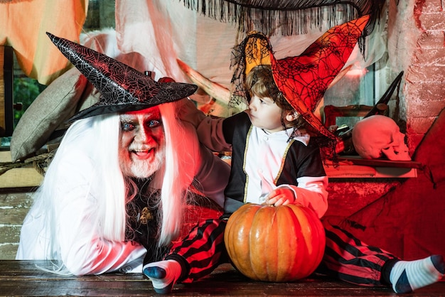 Father and son in carnival costumes are waiting for guests and sweets Happy Father and Children boy