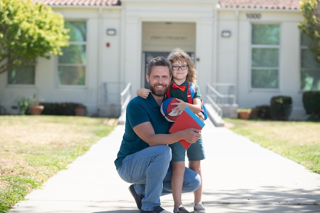 Father and son come back from school hugging, back to school