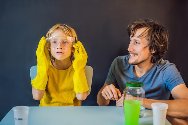 Father and son conduct chemical experiments at home home made slime