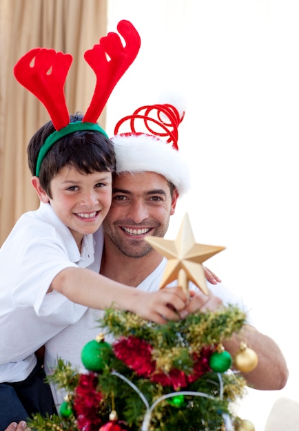 Father and son decorating Christmas tree