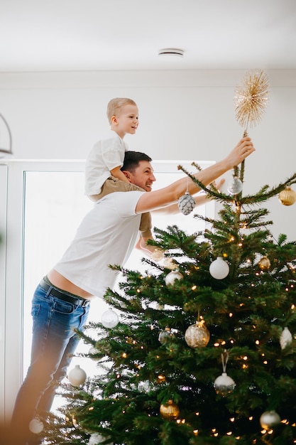 Father and son decorating a Christmas tree