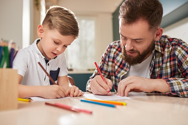 Father and son drawing together