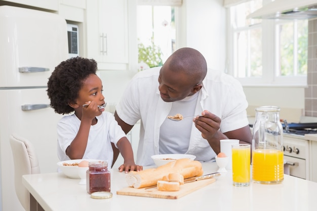 Father and son eating a breakfast