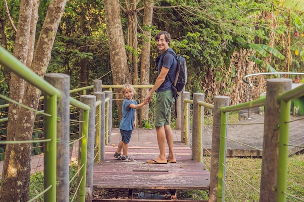 Father and son enjoying a walk in the forest.