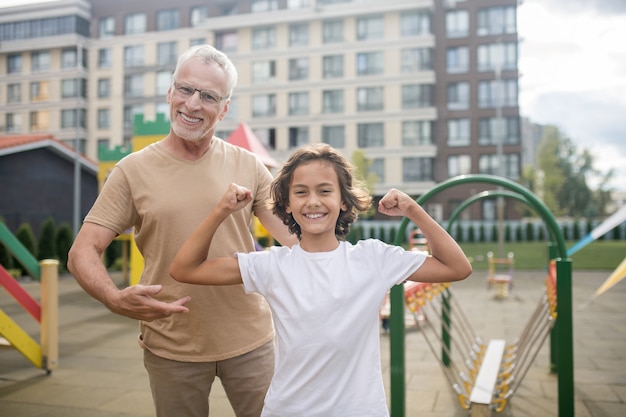 Father and son feeling happy and strong