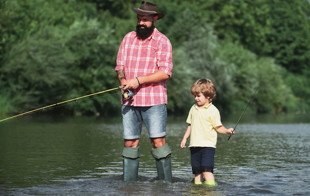 Father and son fishing and relaxing while enjoying hobby anglers fishermen father and son fishing in