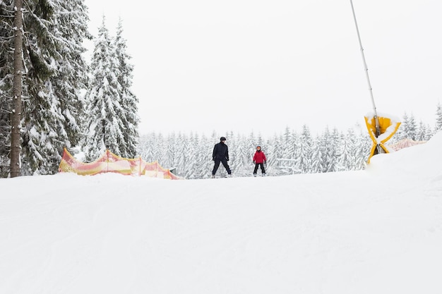 Father and son go skiing. Dad spends time with the child.
