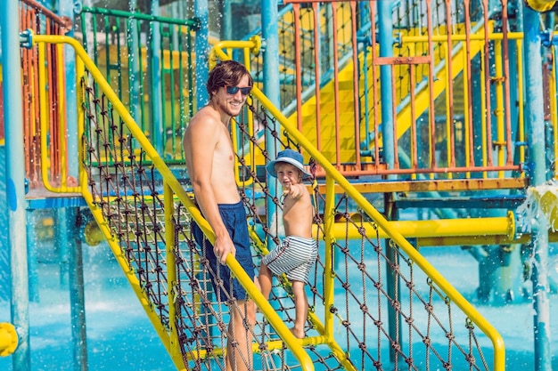 Photo father and son have fun at the water park.