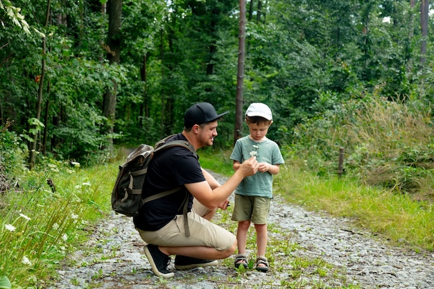 Father and son have a time together in summer forest