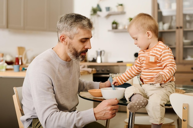 father and son having breakfast together