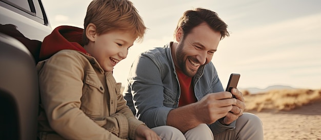 Father and son having fun while using mobile phone outdoors