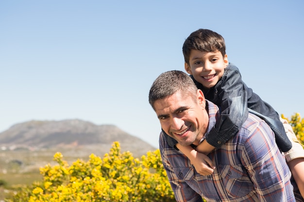 Father and son hiking through mountains 