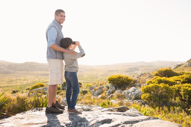 Father and son hiking through mountains 