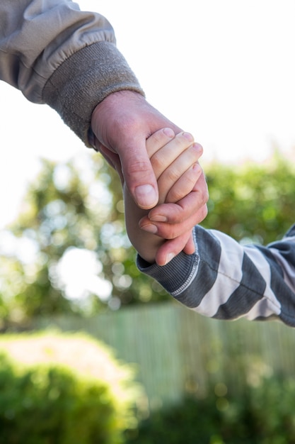 Father and son holding hands